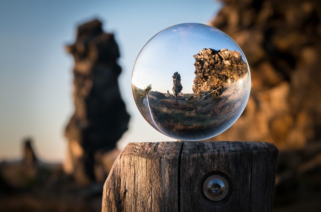 Glass sphere viewing a large rock.